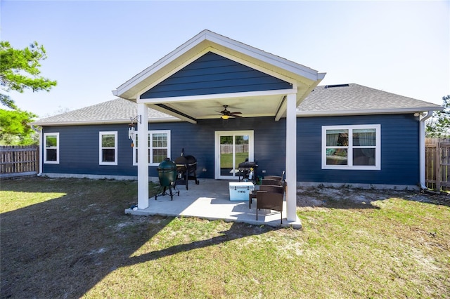 back of house featuring ceiling fan, a patio area, and a lawn