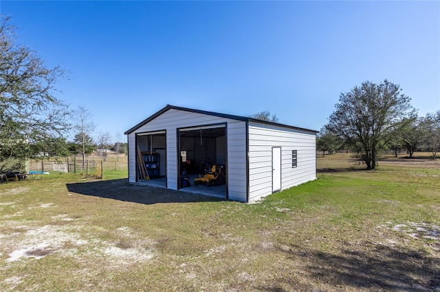 view of outdoor structure with a garage and a lawn