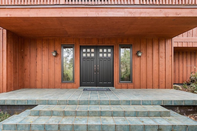 property entrance featuring board and batten siding