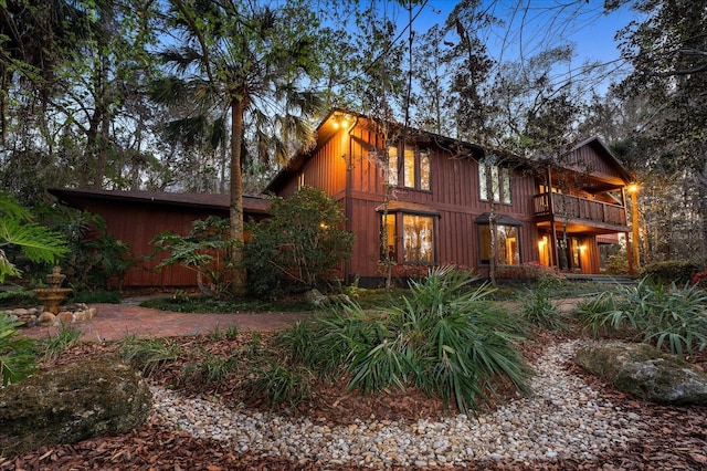 back of property with a balcony