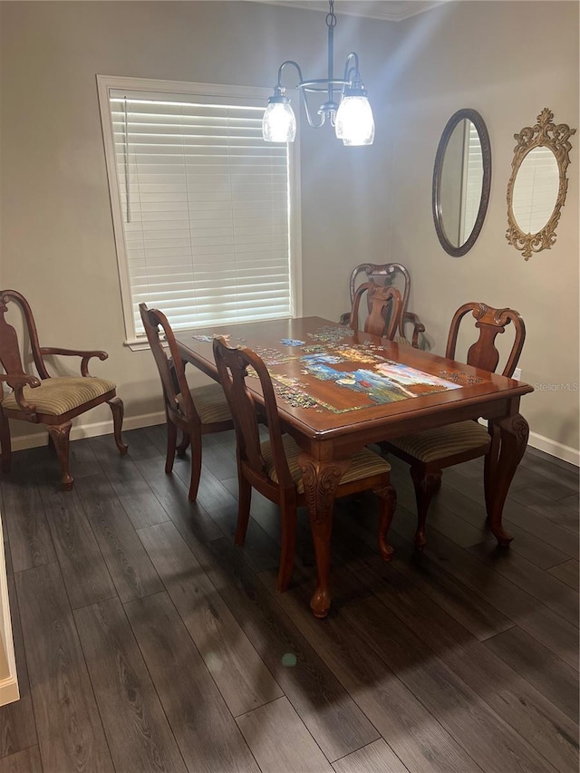 dining space featuring baseboards, a chandelier, and dark wood-style flooring