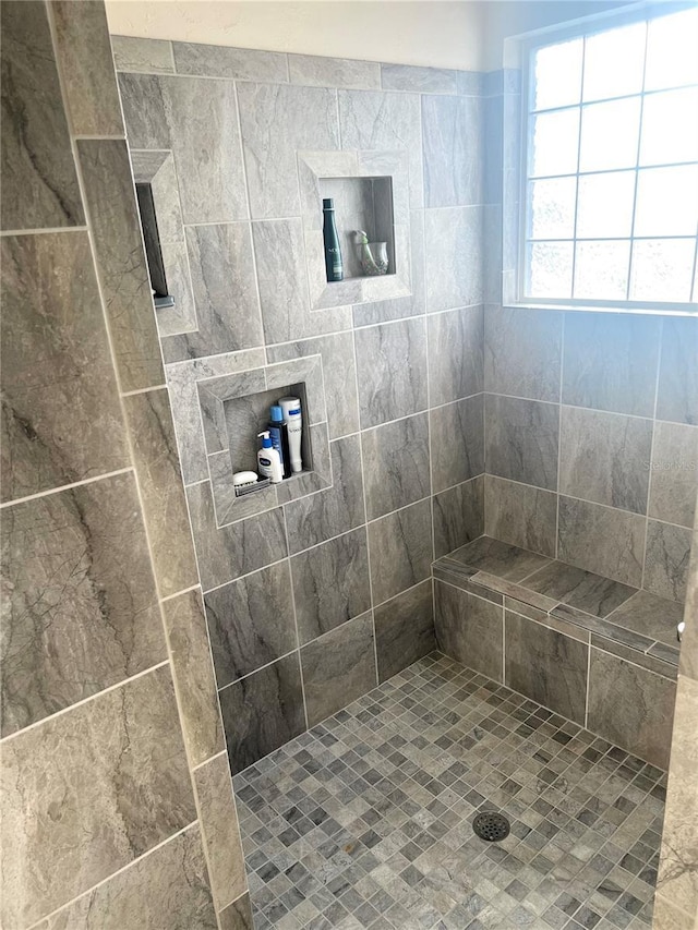 bathroom with a tile shower