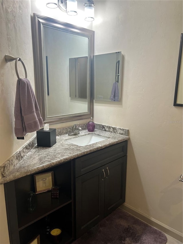 bathroom featuring vanity and baseboards