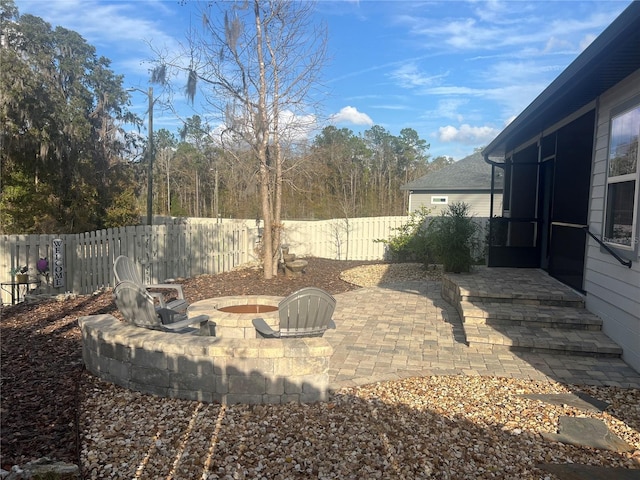 view of patio / terrace with a fenced backyard and a fire pit