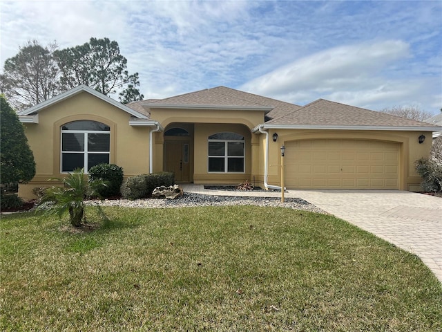 single story home featuring a garage and a front lawn