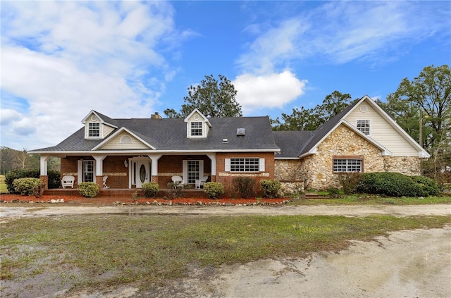 22617 NW 202nd St, High Springs, FL 32643 - view of front of house featuring covered porch, a chimney, stone siding, and brick siding