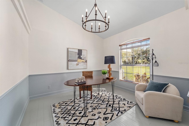 home office with a wainscoted wall, baseboards, a chandelier, and vaulted ceiling