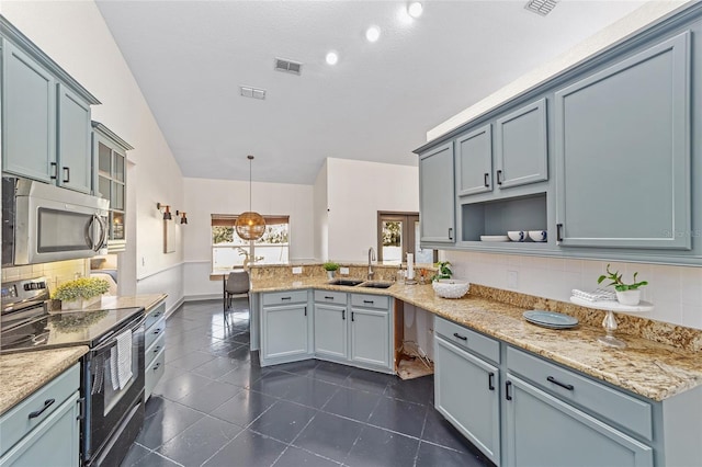 kitchen with a peninsula, electric range, a sink, visible vents, and stainless steel microwave