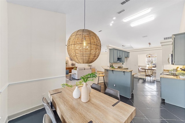 dining area with visible vents, dark tile patterned floors, and baseboards