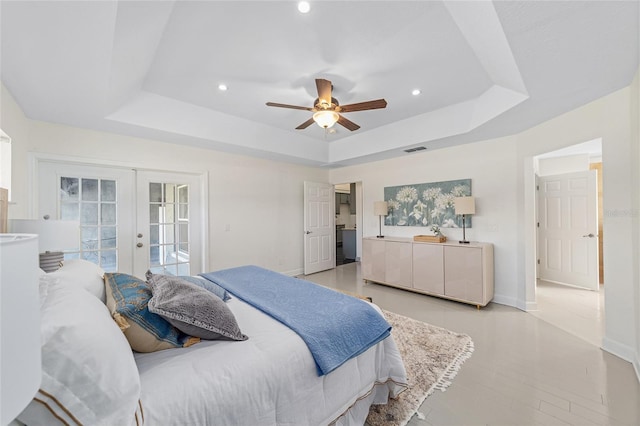 bedroom featuring french doors, a tray ceiling, visible vents, and access to exterior