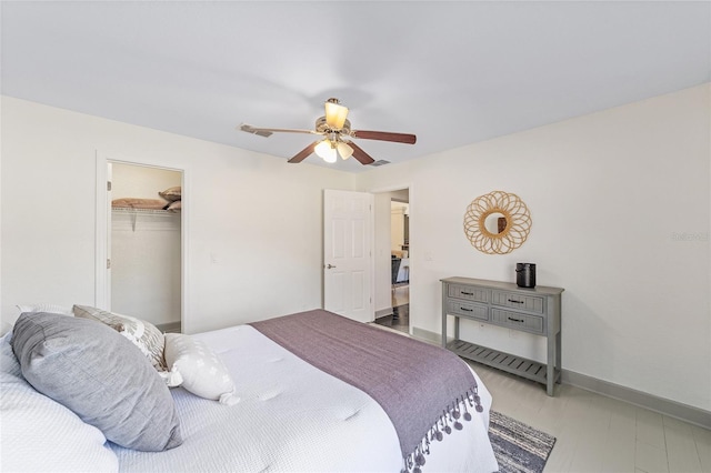 bedroom featuring a ceiling fan, visible vents, and baseboards