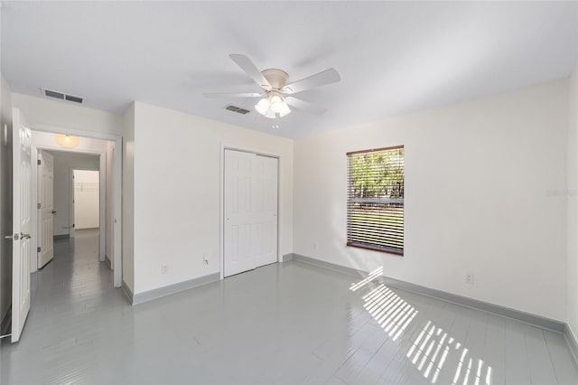 unfurnished bedroom with a closet, visible vents, ceiling fan, and baseboards