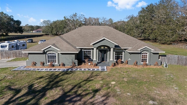 single story home with a front lawn, fence, and stucco siding