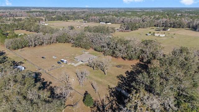 birds eye view of property featuring a forest view