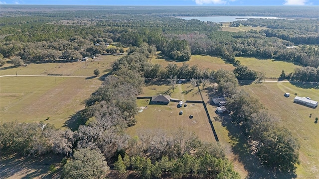 aerial view featuring a forest view and a rural view