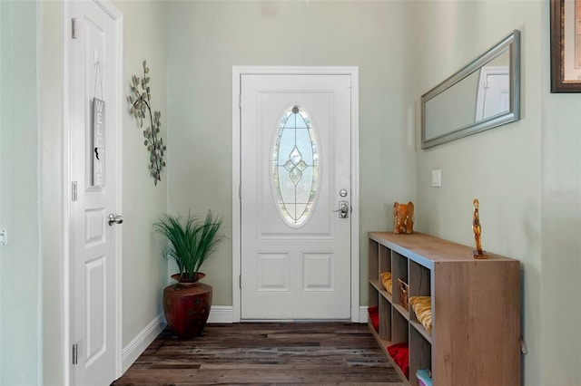 entrance foyer with dark wood-type flooring and baseboards