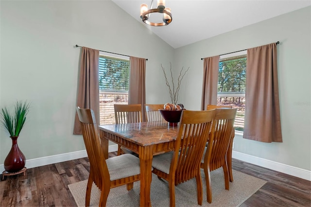 dining room with an inviting chandelier, baseboards, vaulted ceiling, and dark wood finished floors