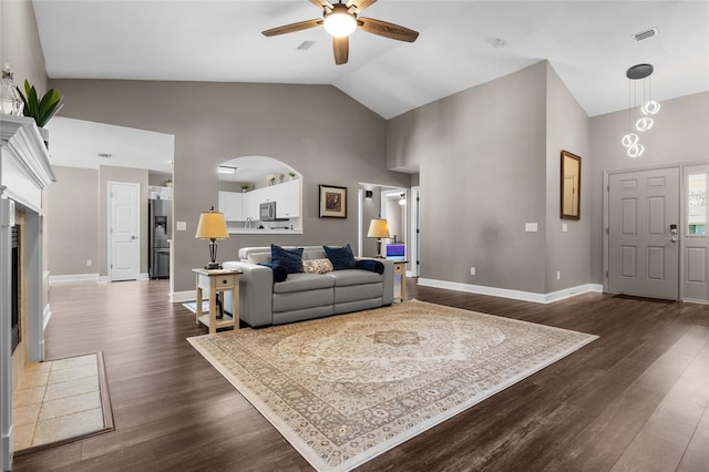 living area featuring visible vents, baseboards, dark wood-style flooring, and a tiled fireplace