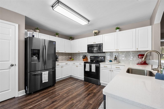 kitchen with tasteful backsplash, dark wood-style floors, white cabinets, stainless steel appliances, and a sink