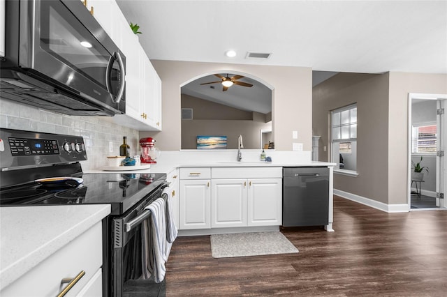 kitchen with light countertops, dark wood-style flooring, appliances with stainless steel finishes, and a sink