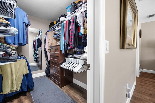 walk in closet featuring wood finished floors and visible vents