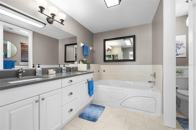 full bathroom with toilet, double vanity, a bath, tile patterned floors, and a sink