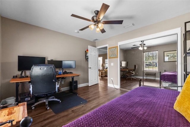 bedroom featuring visible vents, a ceiling fan, baseboards, and wood finished floors