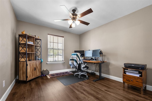 office space featuring ceiling fan, baseboards, and wood finished floors