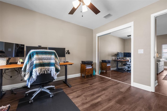 office with ceiling fan, wood finished floors, visible vents, and baseboards