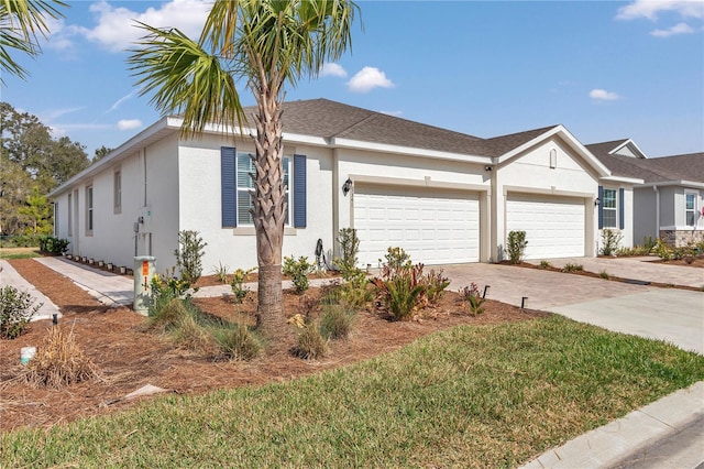 ranch-style house with a garage and a front lawn