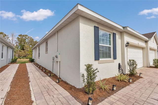 view of side of property with a garage