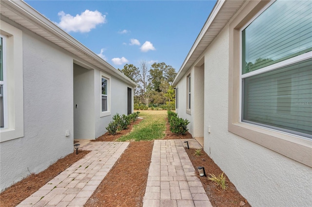 view of side of property with a patio area