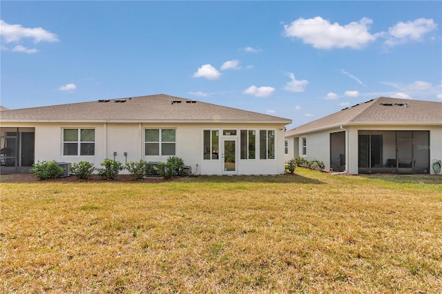 back of property with a sunroom, central air condition unit, and a lawn