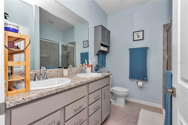 bathroom with vanity, toilet, an enclosed shower, and tile patterned flooring