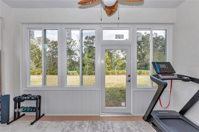 exercise room with ceiling fan and a healthy amount of sunlight