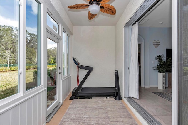 workout area featuring ceiling fan and plenty of natural light