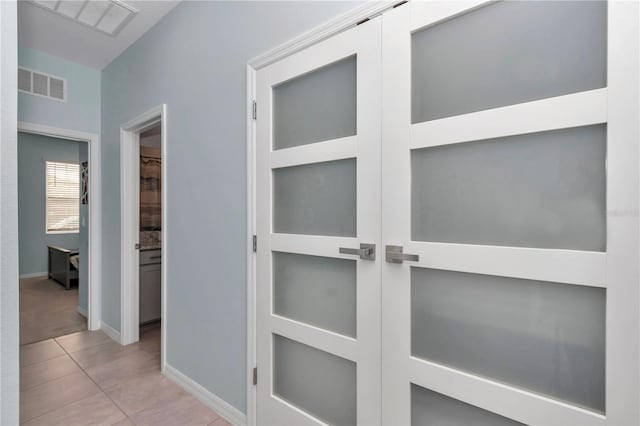 hallway featuring light tile patterned floors