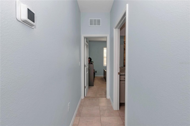 hall with light tile patterned floors