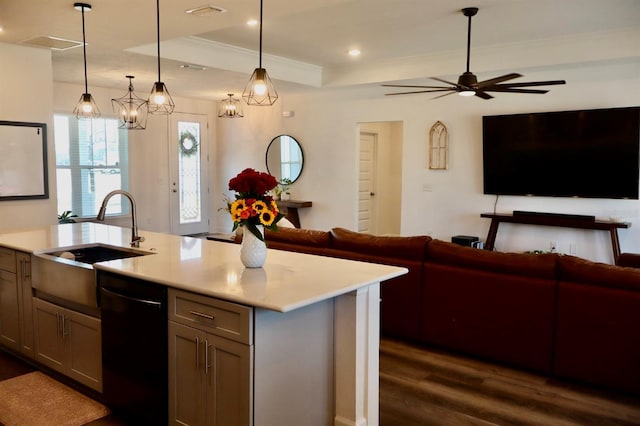 kitchen with a center island with sink, black dishwasher, sink, and decorative light fixtures