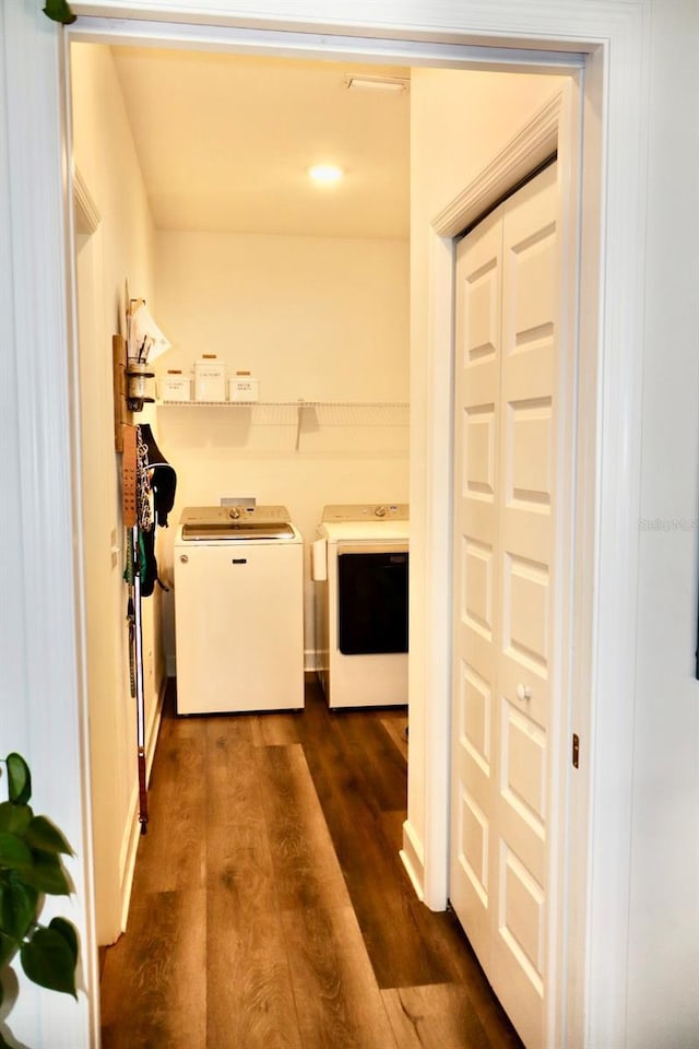 laundry room featuring washer and dryer and dark hardwood / wood-style floors