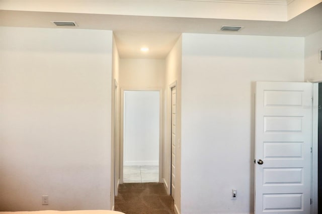 hallway featuring dark carpet