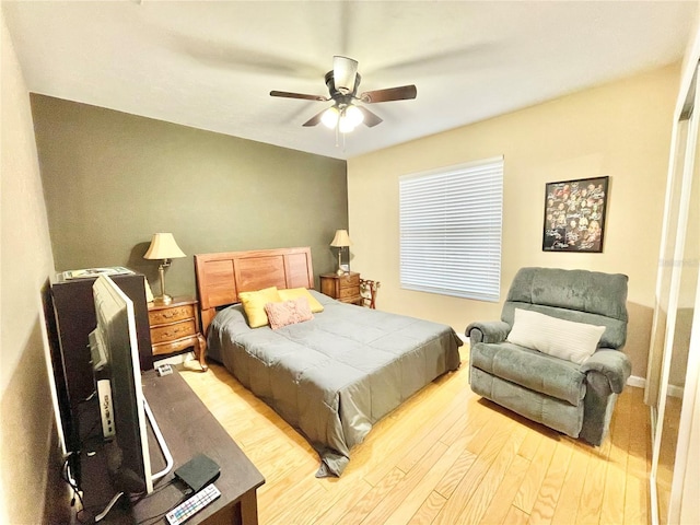 bedroom with light hardwood / wood-style floors and ceiling fan