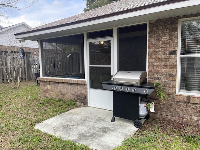 view of patio / terrace with a grill and a sunroom