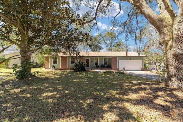 ranch-style house featuring a garage, driveway, and a front lawn