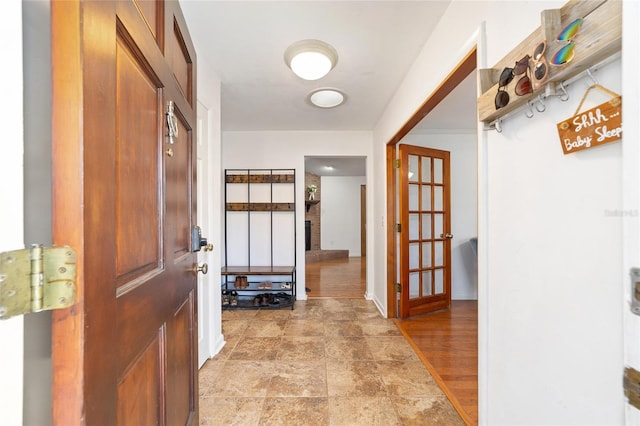 interior space featuring light wood-type flooring and baseboards