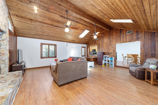 living room featuring a skylight, wooden ceiling, a wall unit AC, and wood finished floors