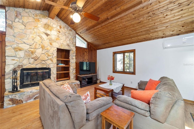 living room featuring a stone fireplace, a wall mounted AC, wooden ceiling, and wood finished floors