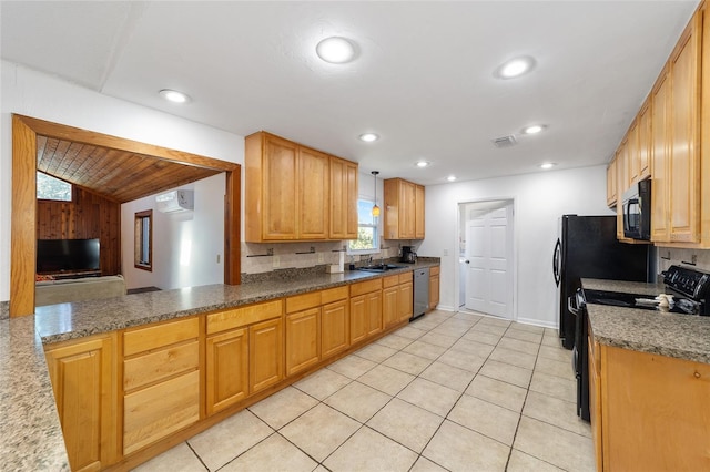 kitchen featuring a wall unit AC, recessed lighting, light tile patterned flooring, a sink, and black appliances