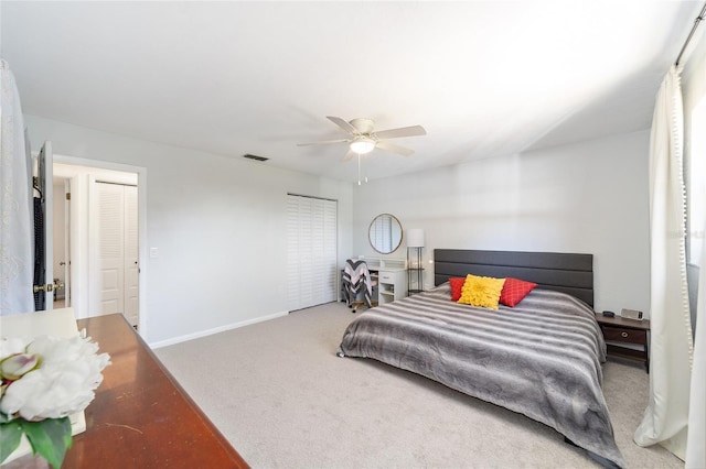 bedroom featuring a ceiling fan, baseboards, visible vents, and carpet flooring