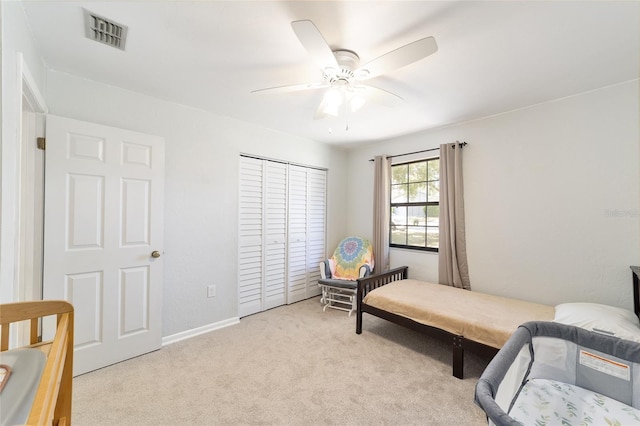 bedroom with carpet floors, a closet, visible vents, ceiling fan, and baseboards